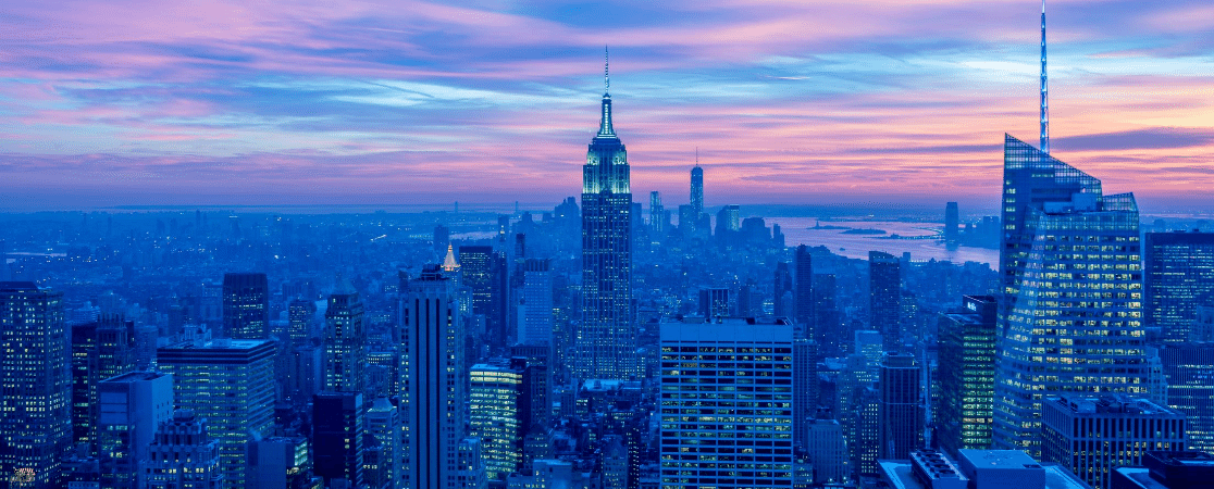 A view of the New York City skyline at dusk