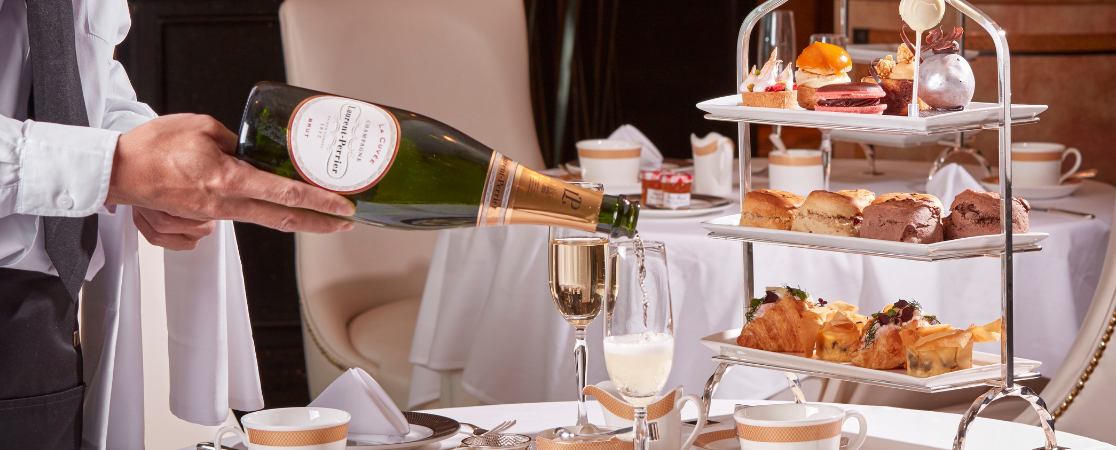 Champagne being poured at afternoon tea